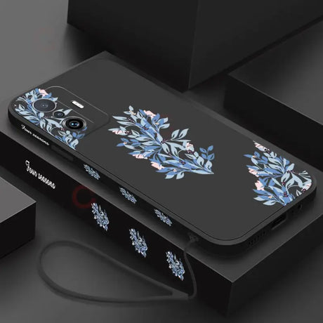 A black phone case with blue flowers on it