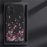 the back of a black phone case with a floral design