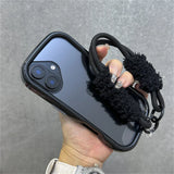 Black phone case with fuzzy strap.