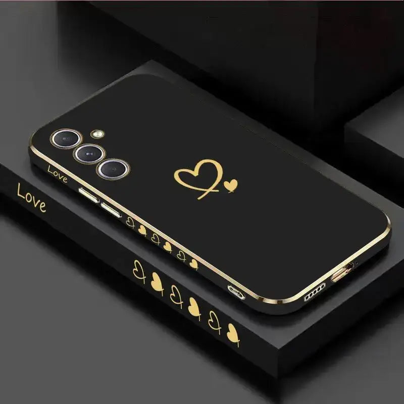 a black phone case with gold hearts and hearts