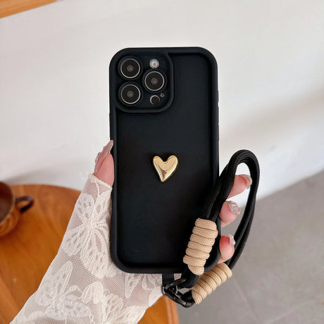 Black phone case with gold heart and lanyard.