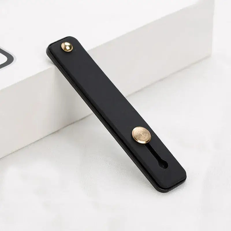 a black phone case with a gold button