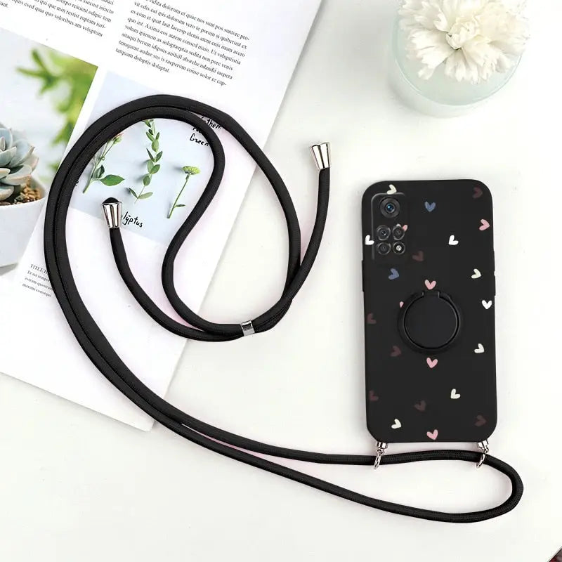 a black phone case with a heart pattern on it