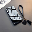 a black phone case with a heart shaped mirror