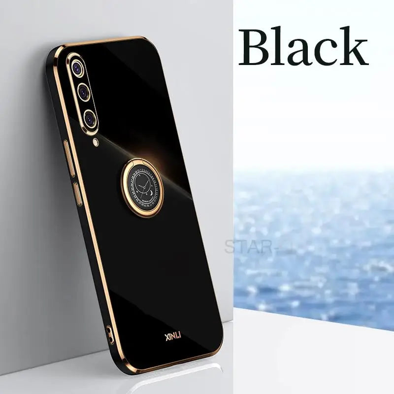 the back of a black iphone case with a gold ring