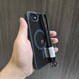Black phone case with lanyard.