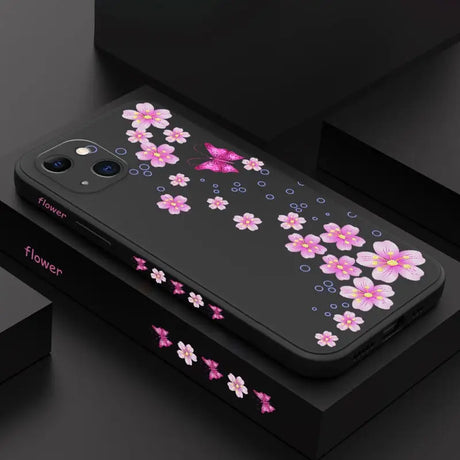 a black phone case with pink flowers on it