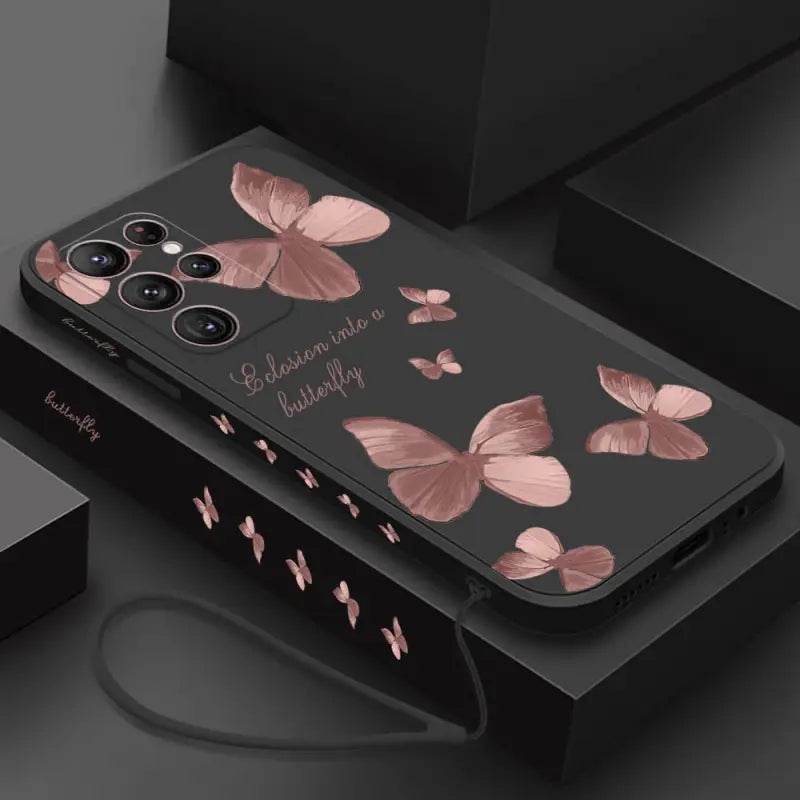 a black phone case with pink butterflies on it
