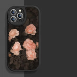a black phone case with pink roses on it