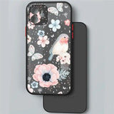 a black phone case with pink flowers and birds