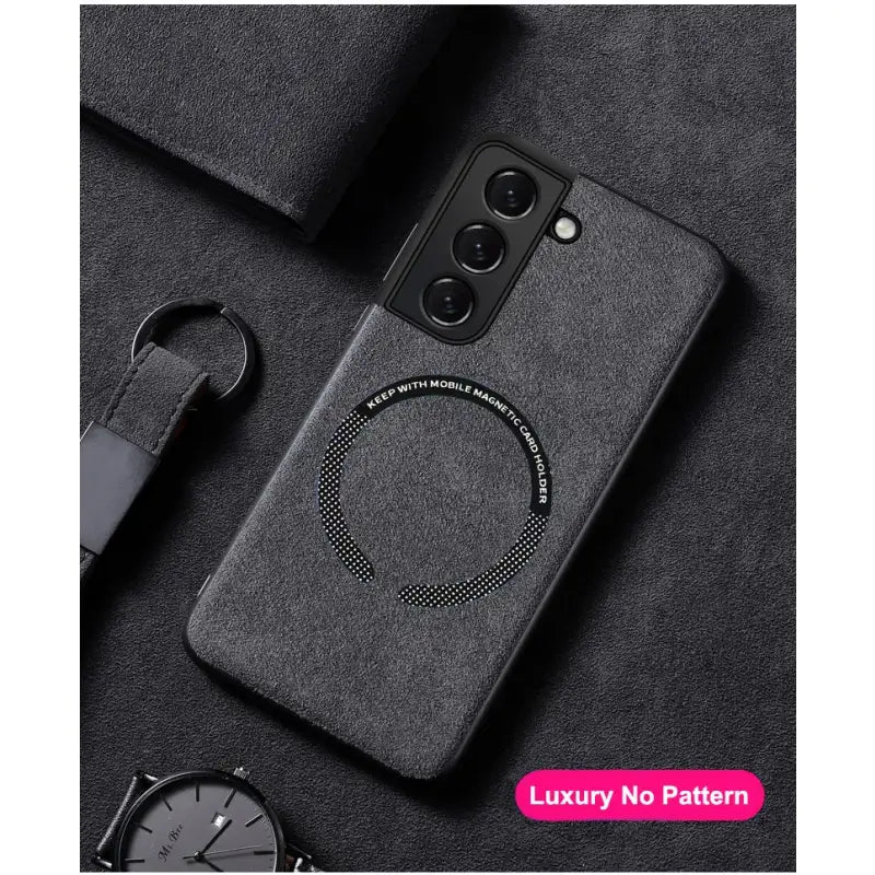 the back of a black phone case with a ring on it