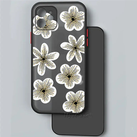 The back of a black phone case with white flowers on it