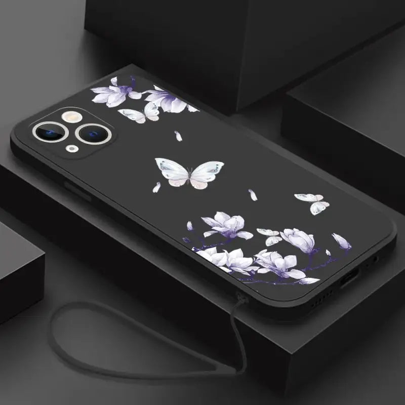 a black phone case with white flowers on it