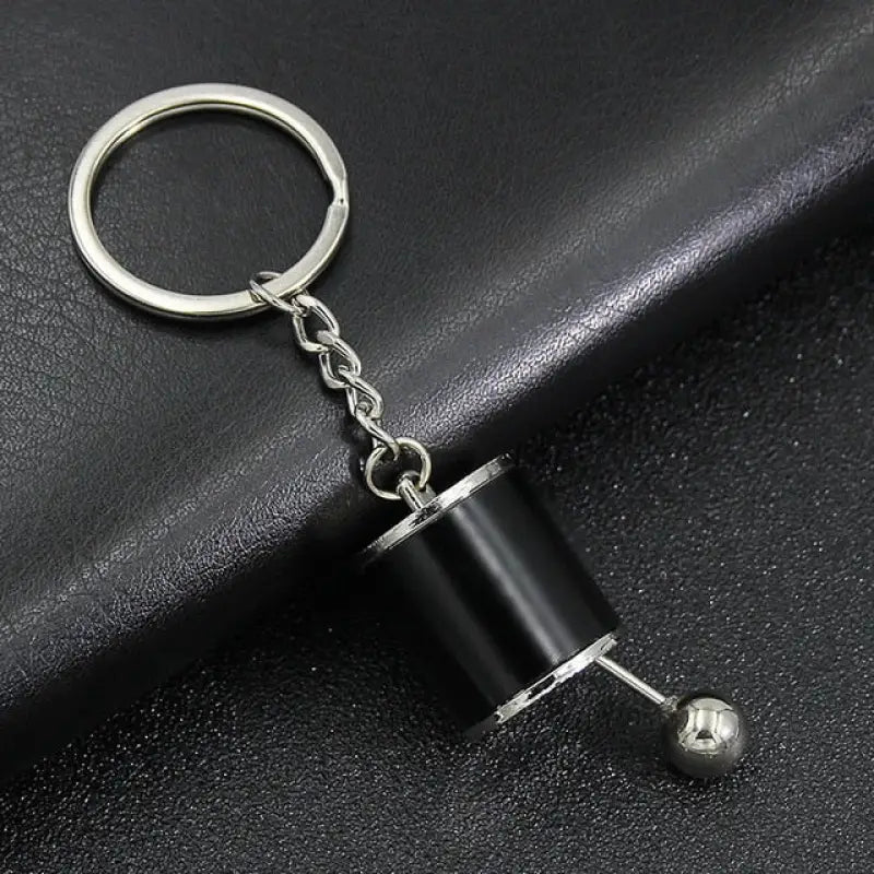 a black keychai with a metal ball on it