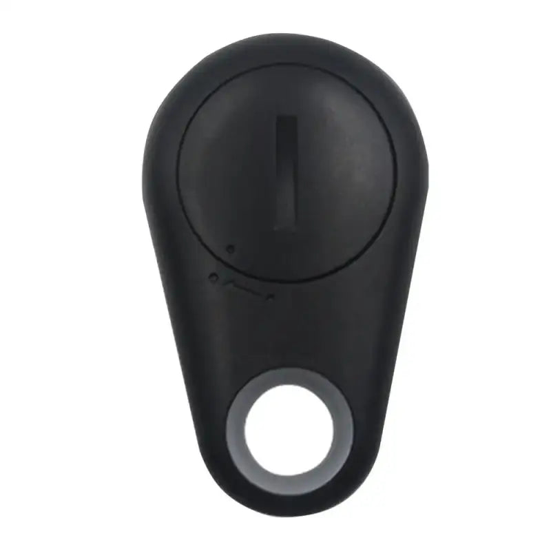 a black plastic key with a white button