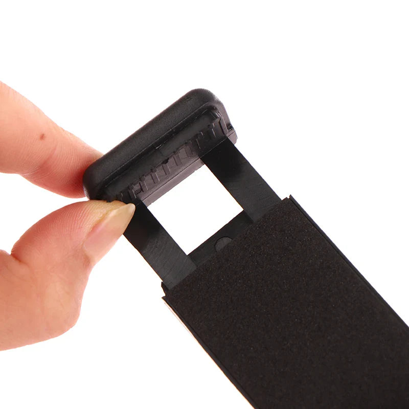 Black plastic webcam cover or privacy slider for electronic devices.