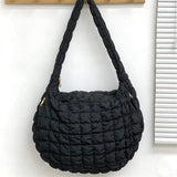 a black purse hanging on a wall