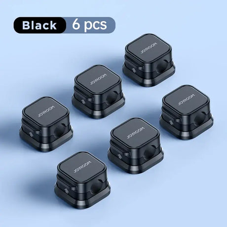 The black qcs wireless earphones are shown in a row