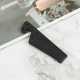 a black metal object on a marble counter