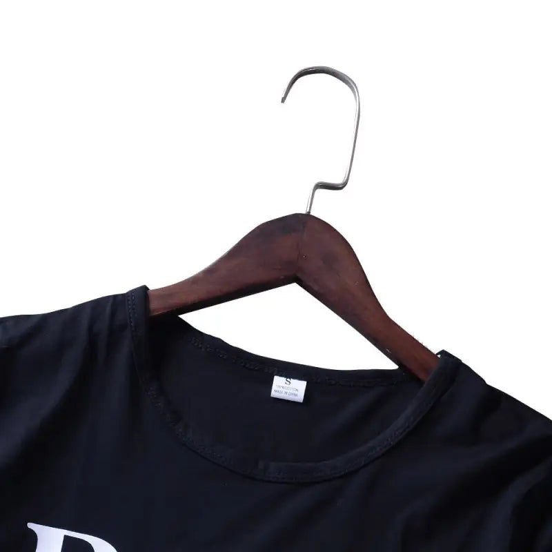 a black t shirt hanging on a hanger