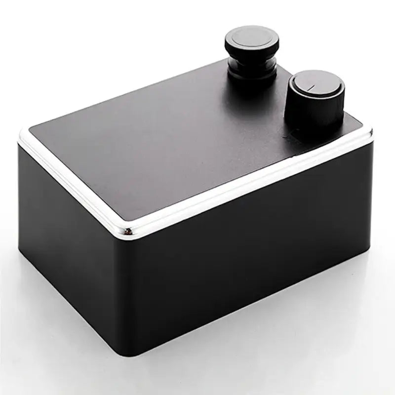 a black and silver metal box with a black knob