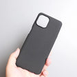 Black smartphone case held in a hand.