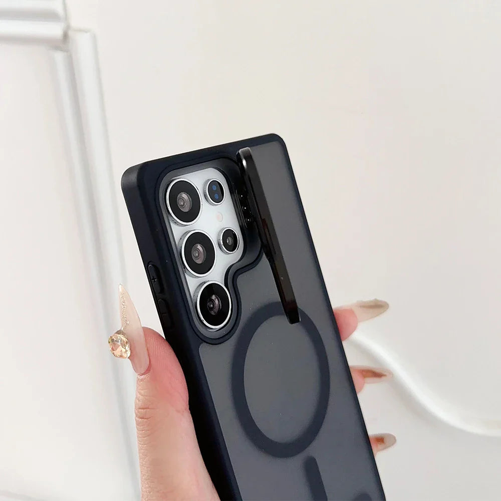 Black smartphone with a multi-lens camera and a clear case featuring a magnetic ring and a kickstand.