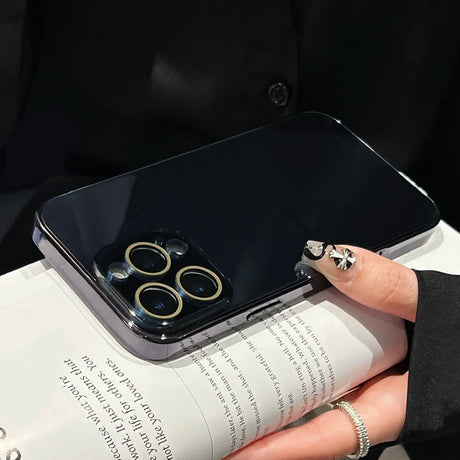 Black smartphone with a triple camera system and a clear protective case.