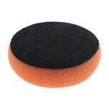 a black sponge with orange foam