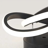 a black table lamp with a white light