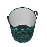 a black and turquoise face mask with a pattern of a swirl
