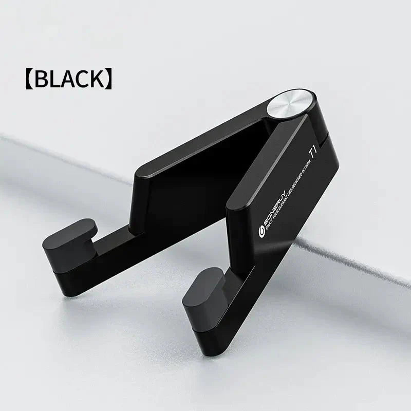 a close up of a black phone holder on a white surface