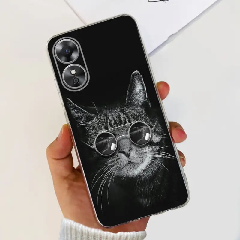 a black cat wearing sunglasses on a black iphone case