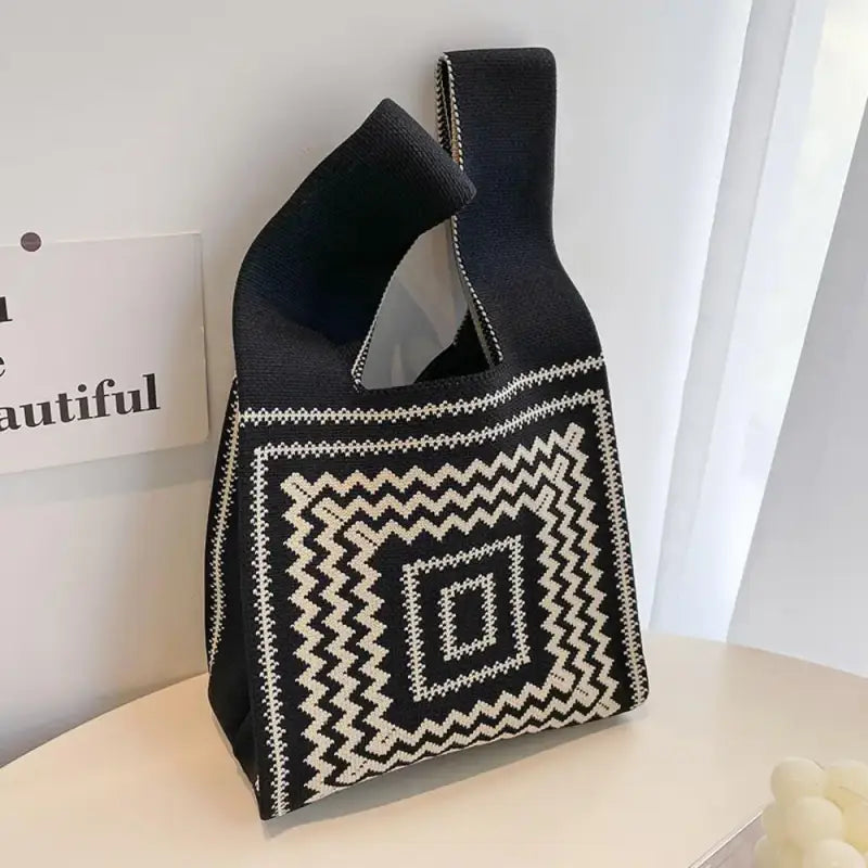 there is a black and white bag with a black and white design