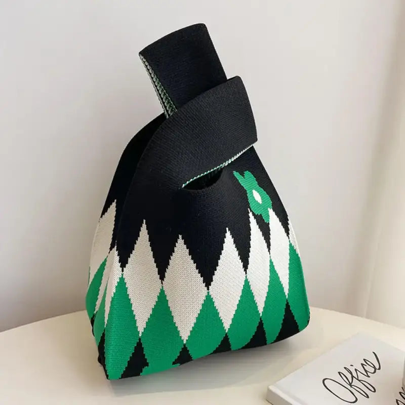 a black and white bag with green and white geometric designs