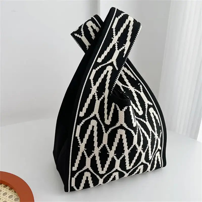 a black and white bag with a pattern on it