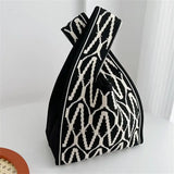 a black and white bag with a pattern on it