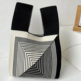 a black and white bag with a square pattern