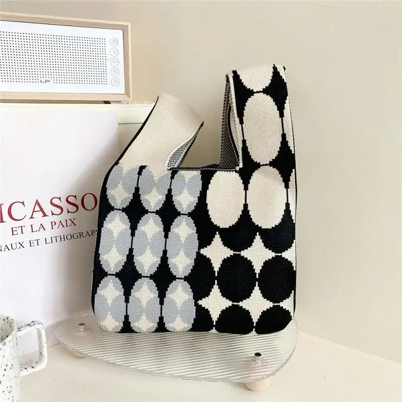 a black and white bag sitting on top of a table