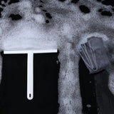 a close up of a white brush and a towel on a black surface