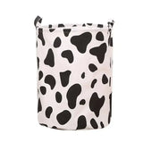 a black and white cow print laundry bag