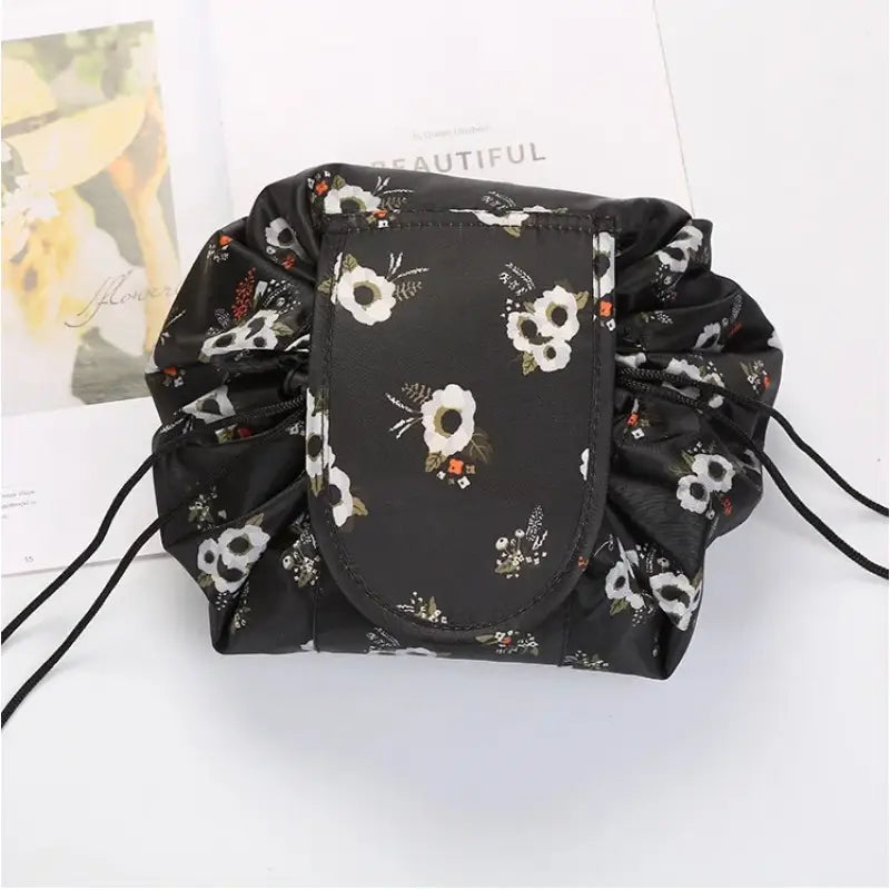 a black and white floral print backpack with a black drawsack