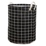 a black and white laundry basket with a white grid pattern