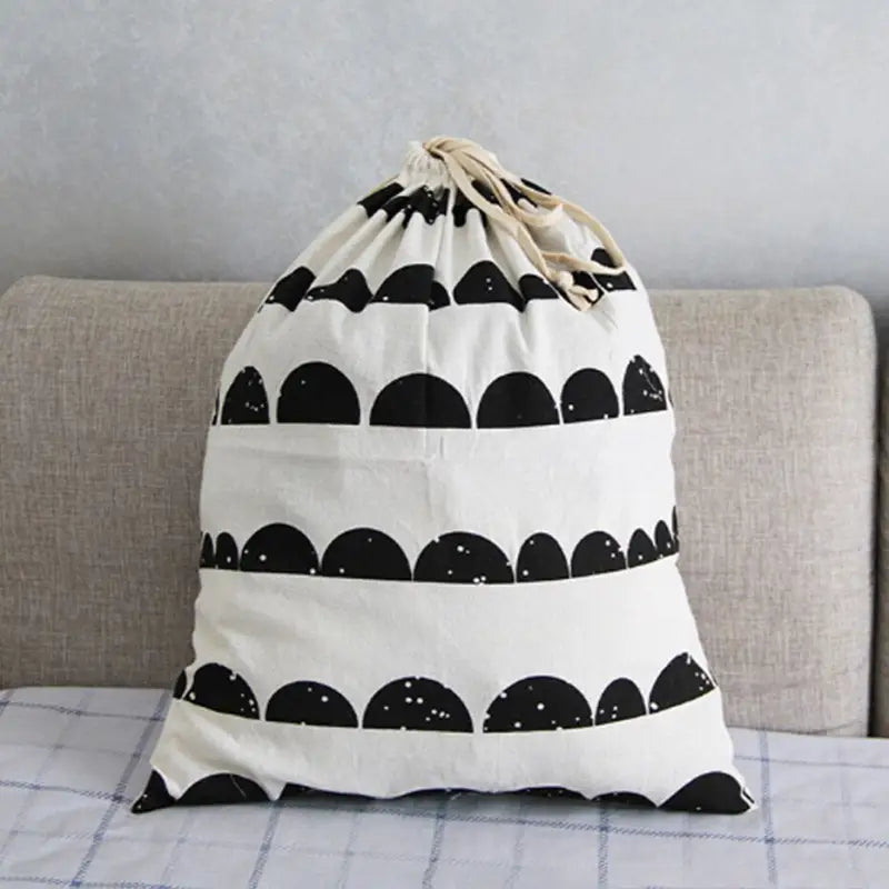 a black and white bag sitting on a couch