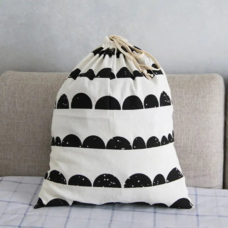 a black and white bag sitting on a couch
