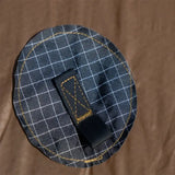 a black and white plaid fabric with a gold and black check pattern