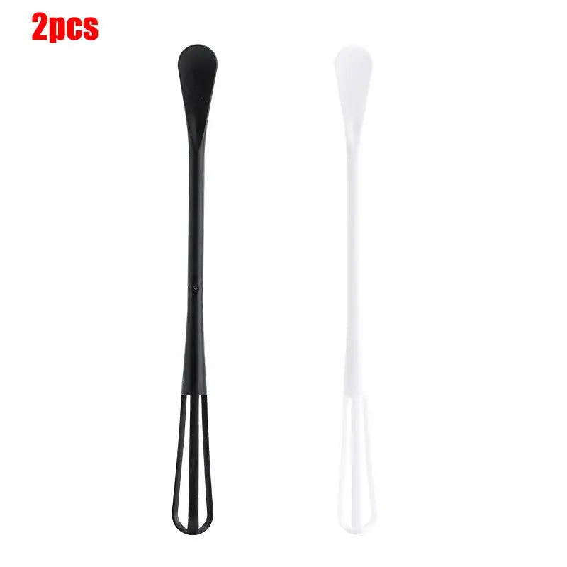 a black and white plastic spoon with a handle