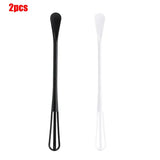 a black and white plastic spoon with a handle