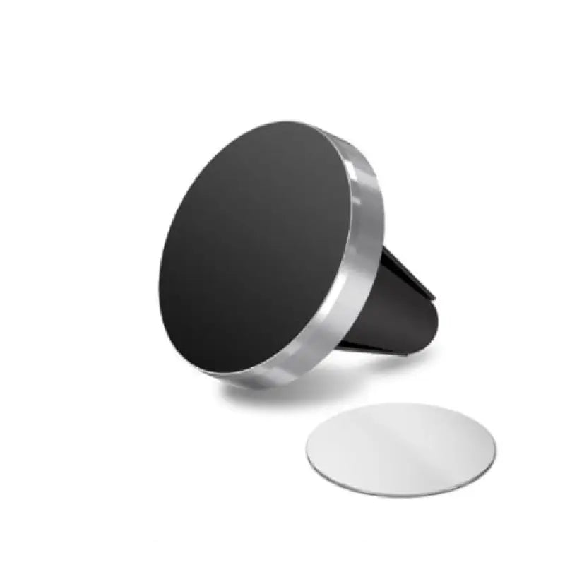 a black and white phone stand with a round mirror