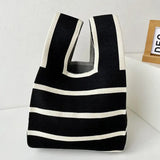 a black and white striped bag sitting on a white table